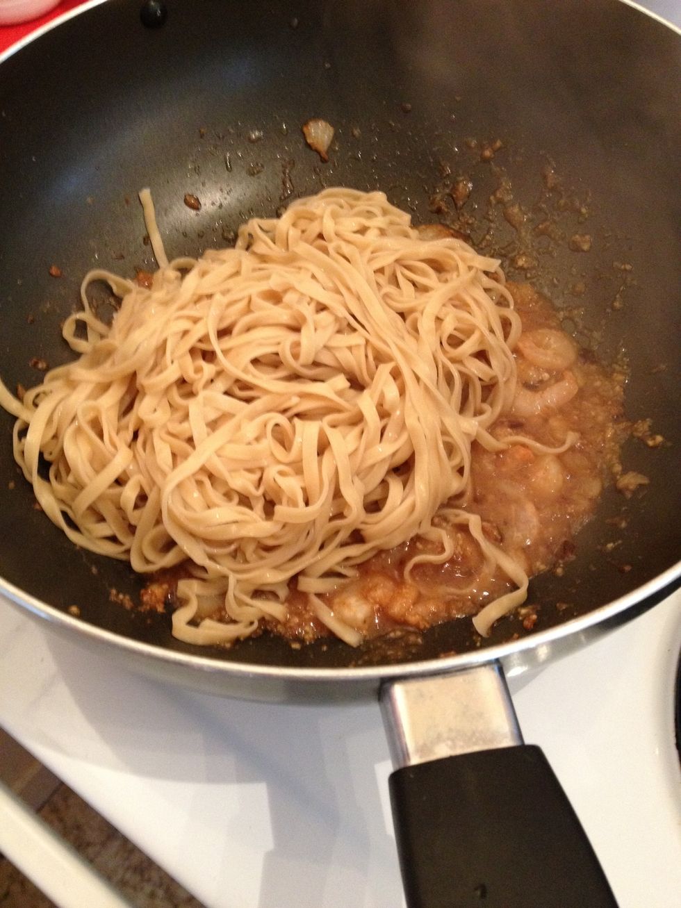 Transfer the noodles to the wok and stir well to ensure they are well coated with the sauce and shrimps.
