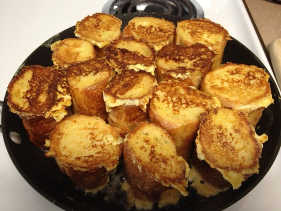 Transfer the oven safe skillet into a pre-heated 400 degree oven for twenty minutes. Warm the syrup and rough chop the strawberries.