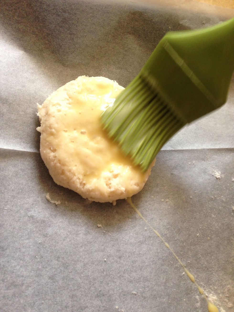 Transfer the scones to the baking sheet and brush the tops of the scones with a little milk.