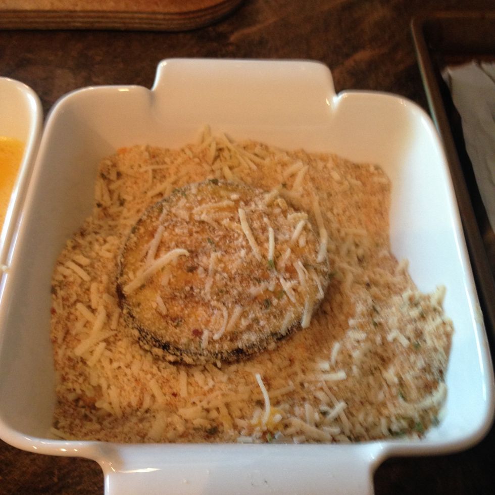 Transfer the slice to the bowl with breadcrumbs and coat evenly.