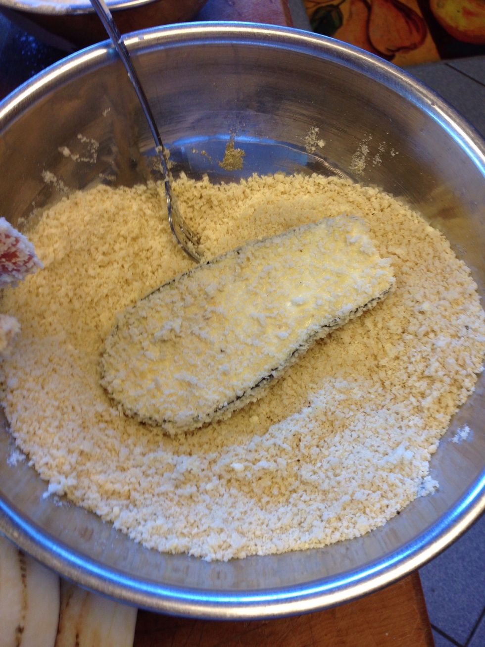 Transfer the soaked eggplant into Panko bowl and cover with the breadcrumb mix
