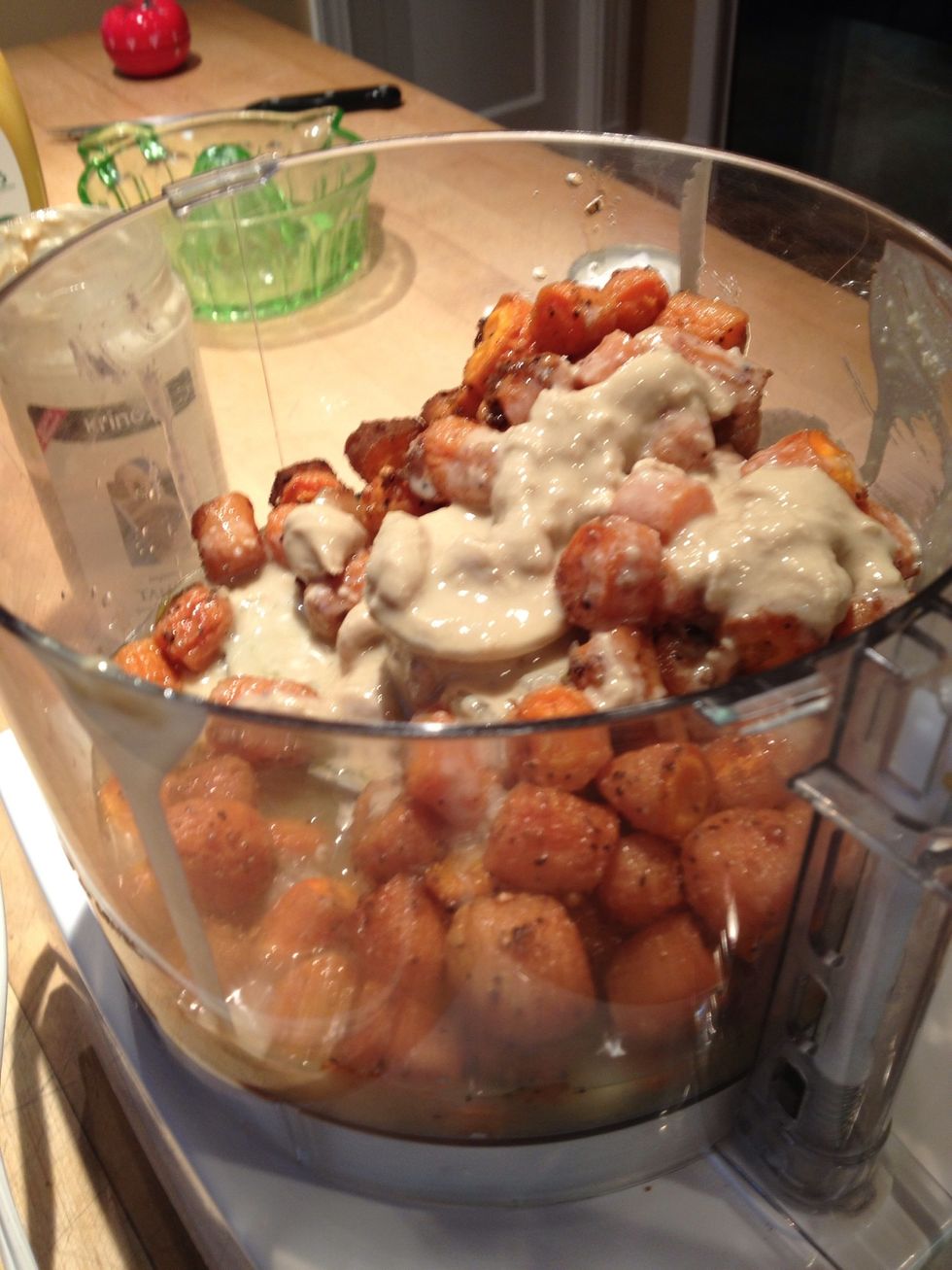 Transfer to a food processor slipping the garlic cloves out of their skins. Scrape in as much of the crusty brown bits, spices and oil as you can get and then add the tahini.