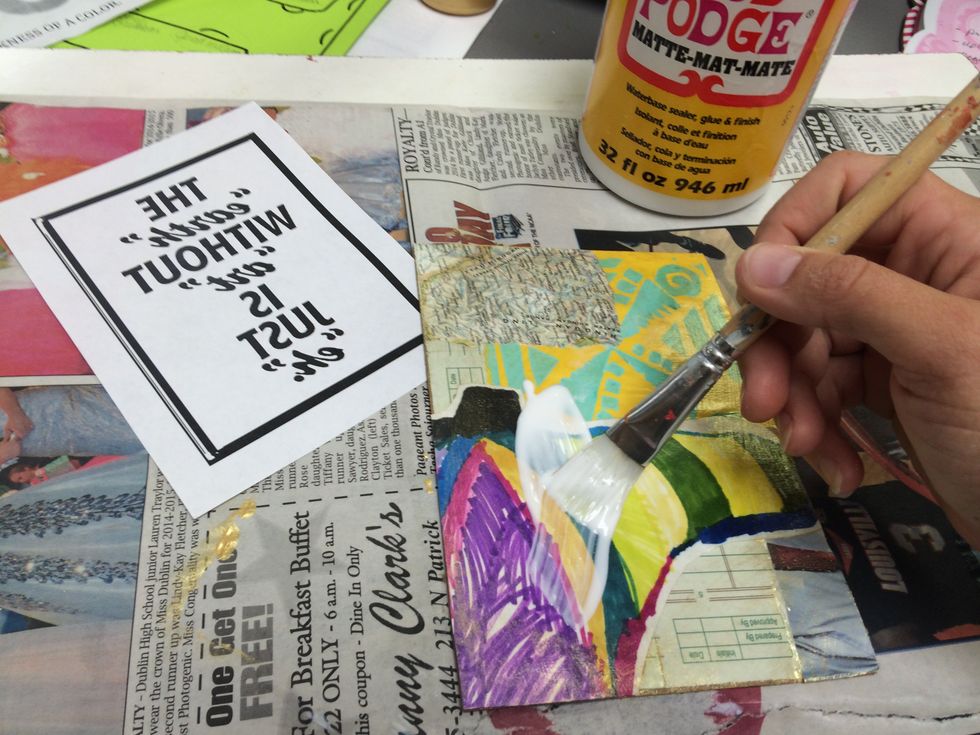 TRANSFER: Use the paint brush to apply a generous yet even amount of Mod-Podge to the collage.