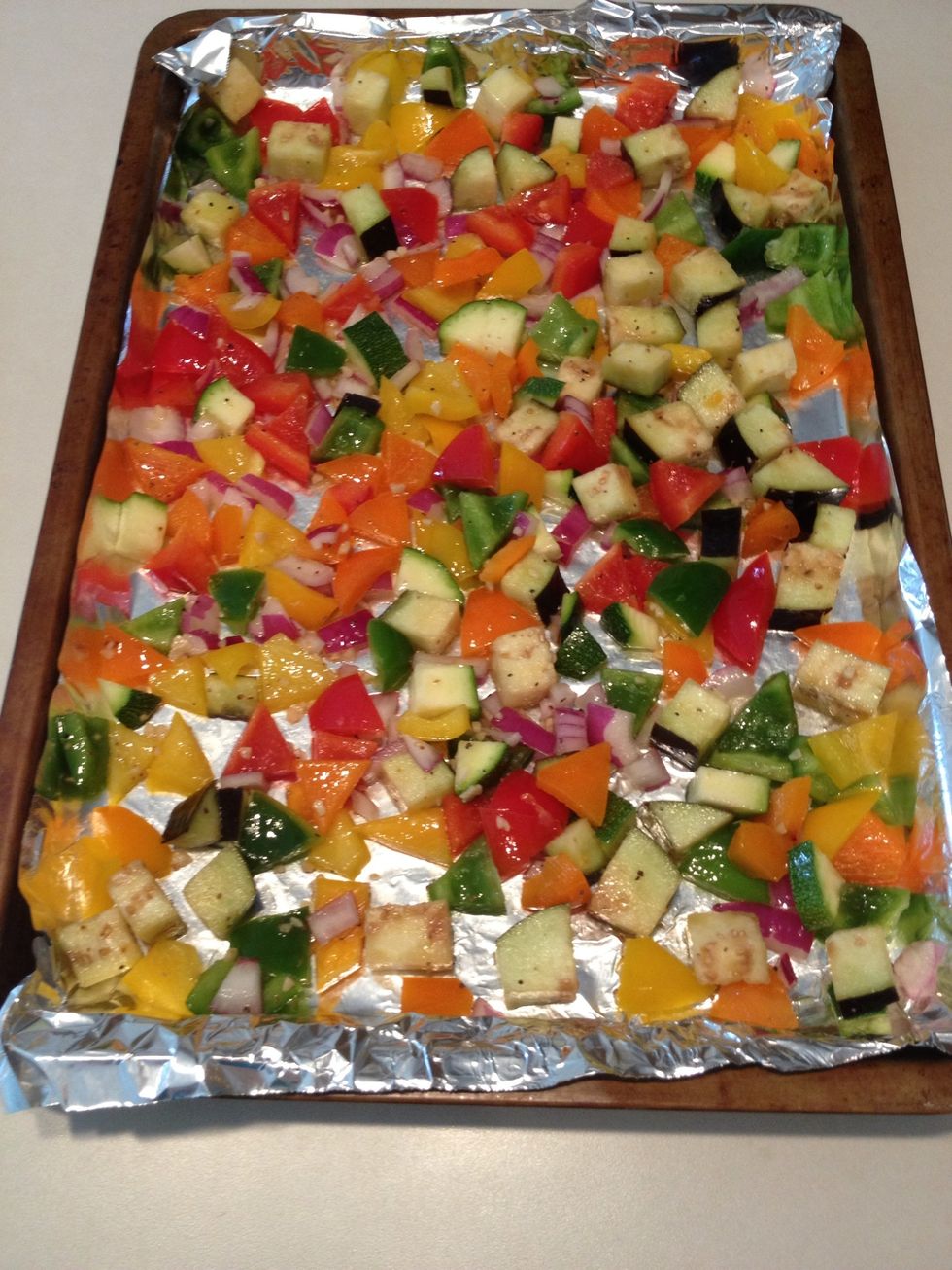 Transfer veggies to baking tray (mine is covered in foil).  Don't dump veggies onto tray because you want to keep some of the sauce in the bowl.  Roast veggies until desired browning occurs.
