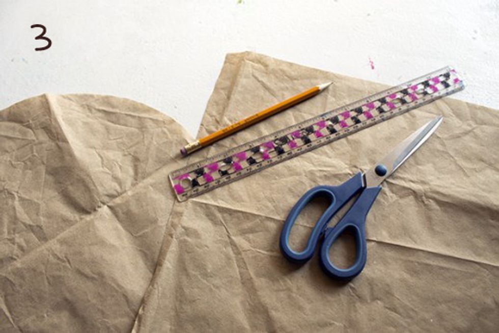 Transfer your measurements to a large piece of paper or newspaper and cut out.