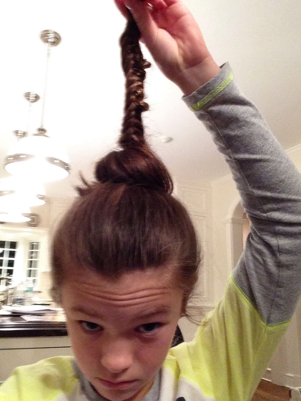 Transform the ponytail into a bun around the fishtail
