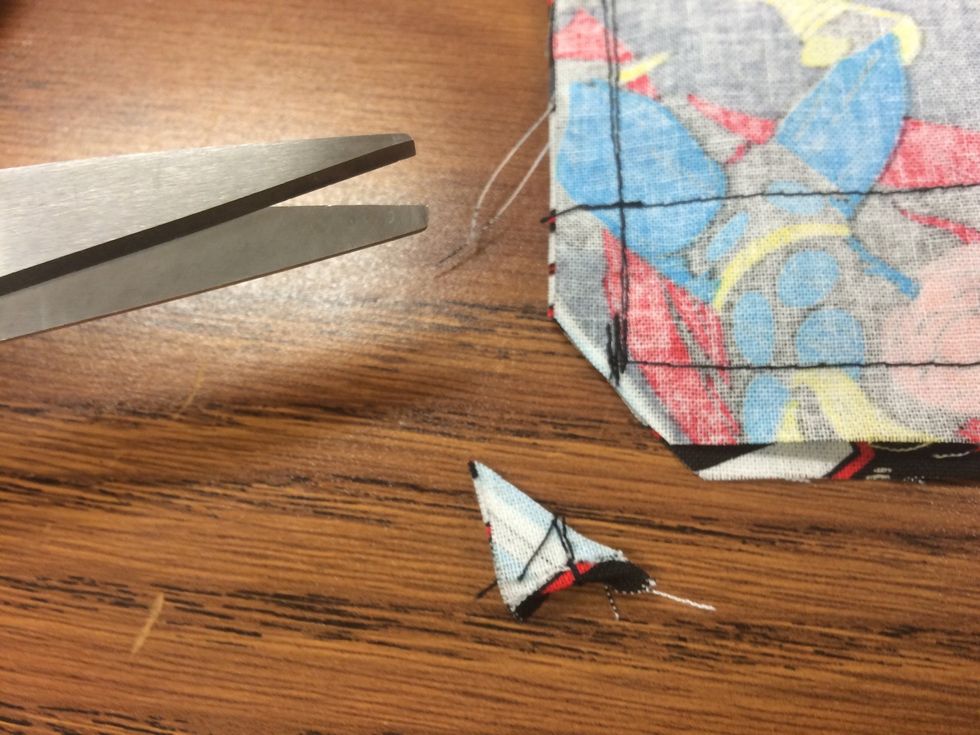 Trim 2 bottom corners to finish edges. Do not cut over the stitch line.