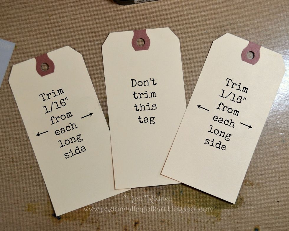 Trim 2 of the #8 hang tags by 1/16" on each long side. These tags will be for the right and left outer pockets which are slightly narrower than the center pocket because of the glued edge.