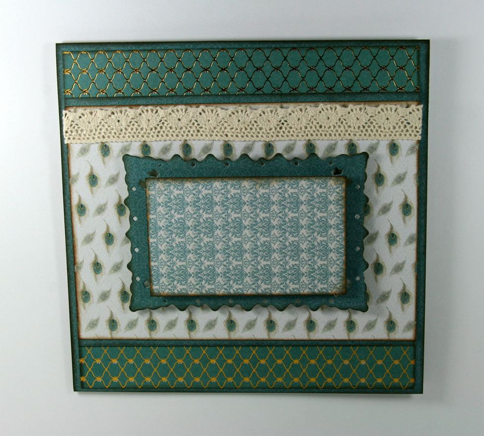 Trim a smaller piece from the patterned paper and adhere with foam spacers to die cut frame.