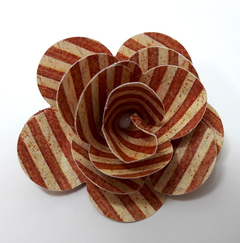 Trim bottom of pieces to create a straight bottom. Attach all pieces together starting from the center. First the rolled piece and then add pieces according to petal number. Finish with large flower.