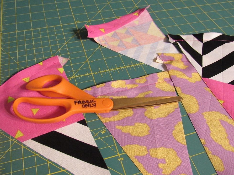Trim excess pieces of fabric from pennant flags and organize them into whatever manner you want to display them on baker\u2019s twine.