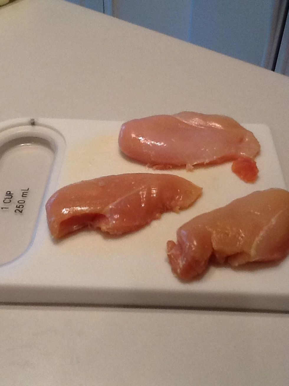 Trim fat off 3 chicken breasts.