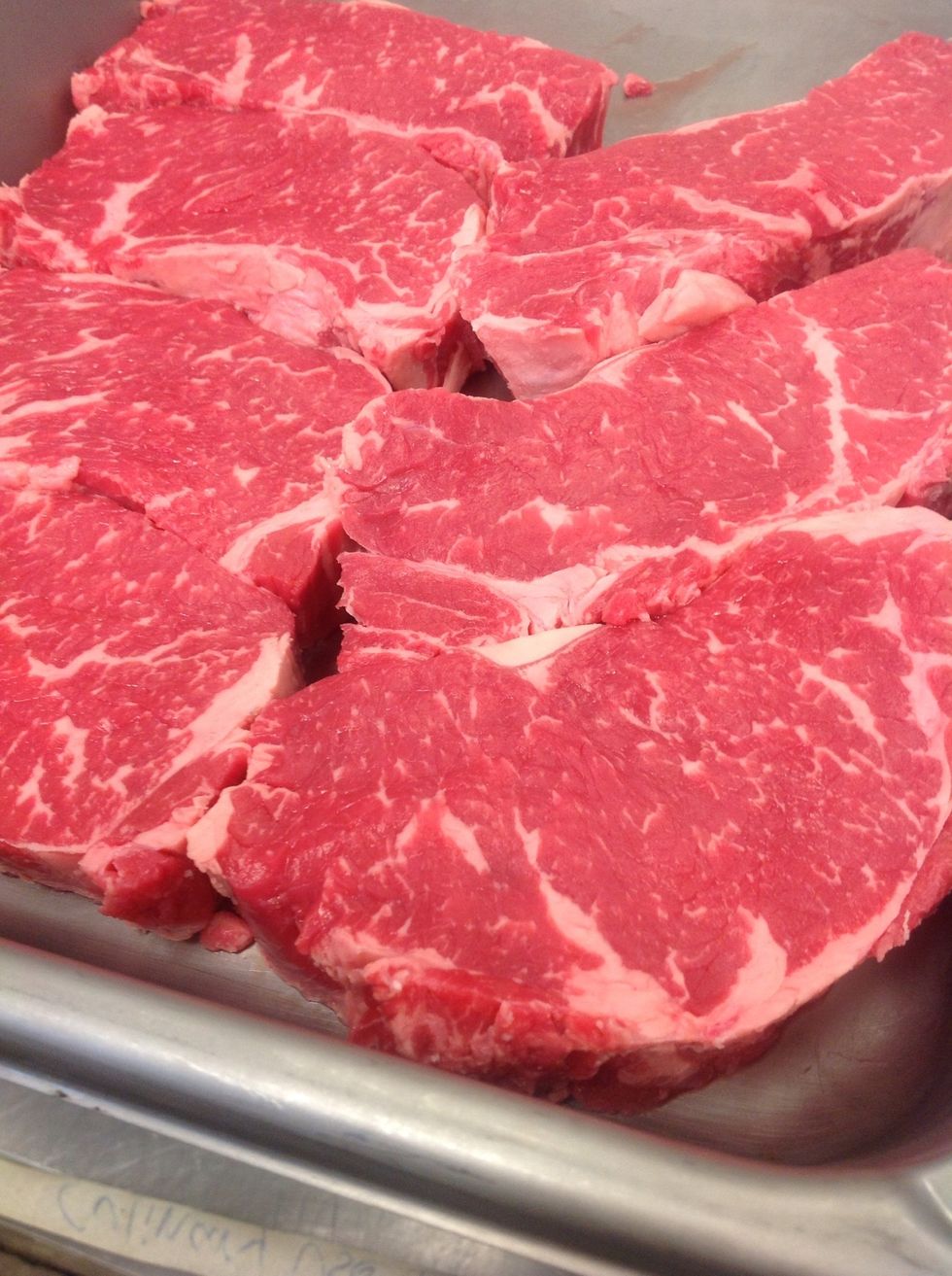 Trim meat and cut into steaks