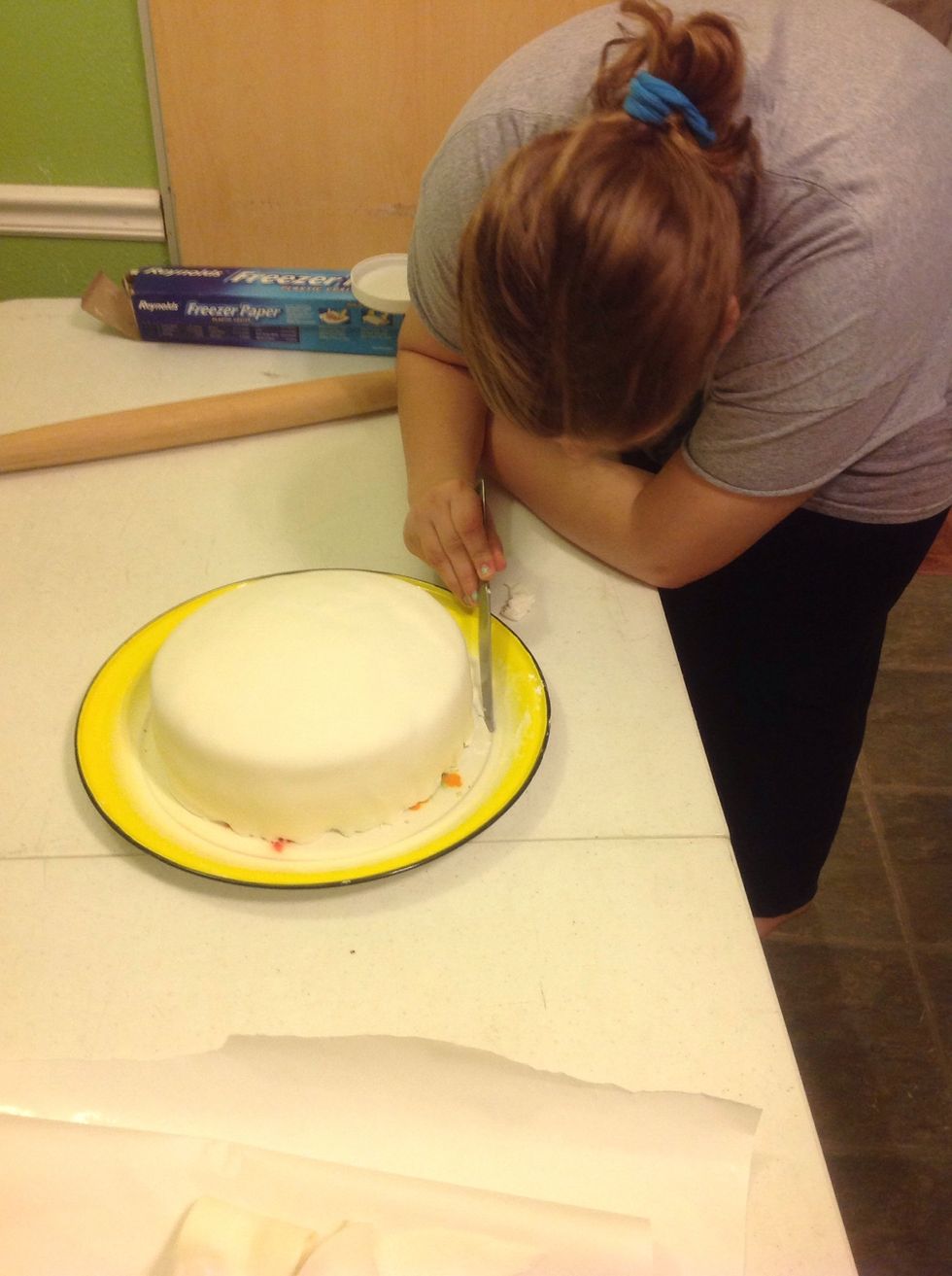 Trim off excess fondant as you smooth it out.