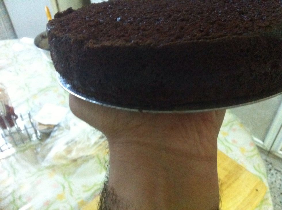 Trim off the top to make it leveled, and if you have one of those 8 inch cake cardboards, then that will make transporting the cake from the turntable to the serving plate a breeze.