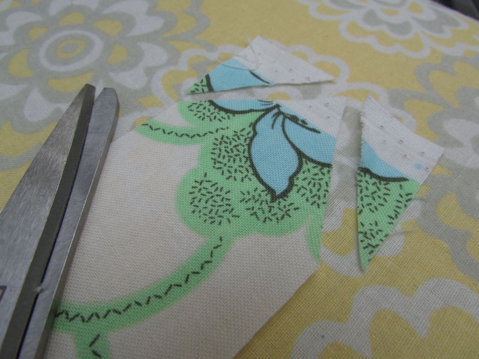 Trim one end of the now long trim strip to a point. This makes it easier to feed the fabric into a tool for making bias trim, that I will now call edge trim ( since it' not based cut!)