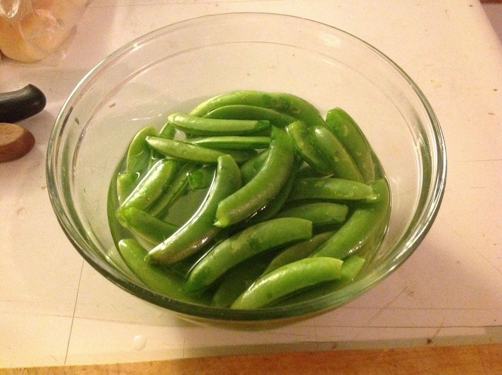 Trim peas- I snap both ends off and peel away the top and bottom zippers.