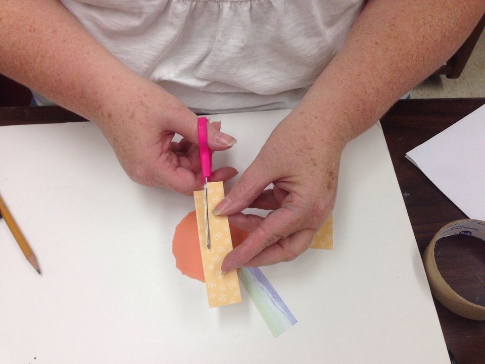 Trim pieces of scrapbook paper into rays for your sun.