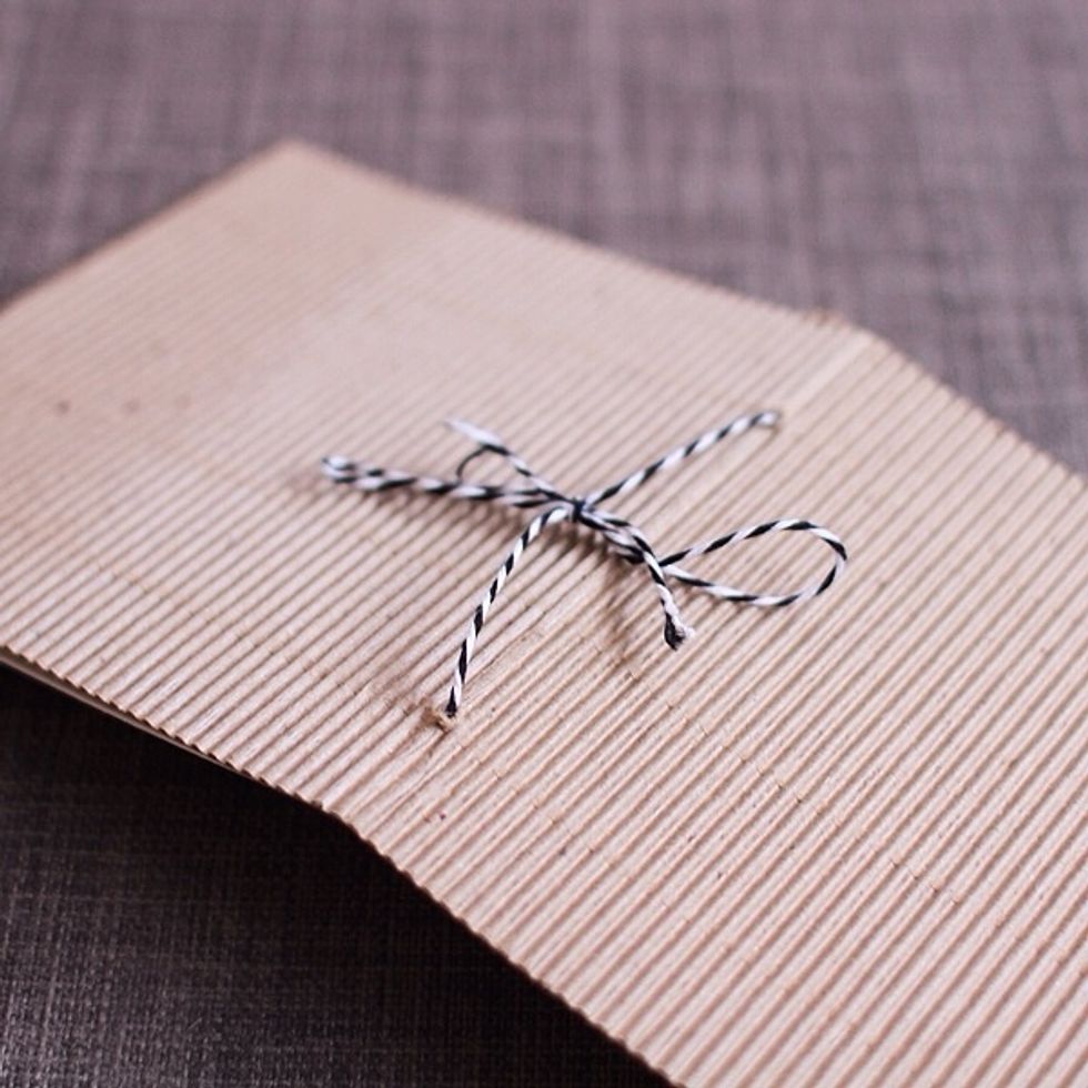 Trim the cardboard paper down to be 12\u2033 x 5\u2033. This makes 2 covers w/ 1 piece of 12\u00d712 cardboard. Fold it at the 5\u2033 mark & again at the 10\u2033 mark. The 2\u2033 flap will fold over to make it a matchbook.