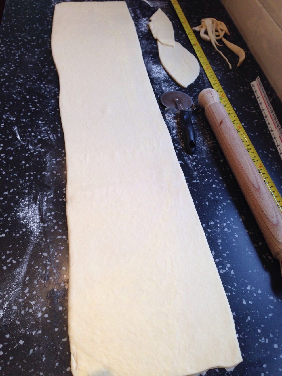 Trim the edges with a pizza cutter. You should have a 100cm length of dough left. (reserve the end pieces make pain au chocolate by placing a piece of dark chocolate in the centre and rolling up!)