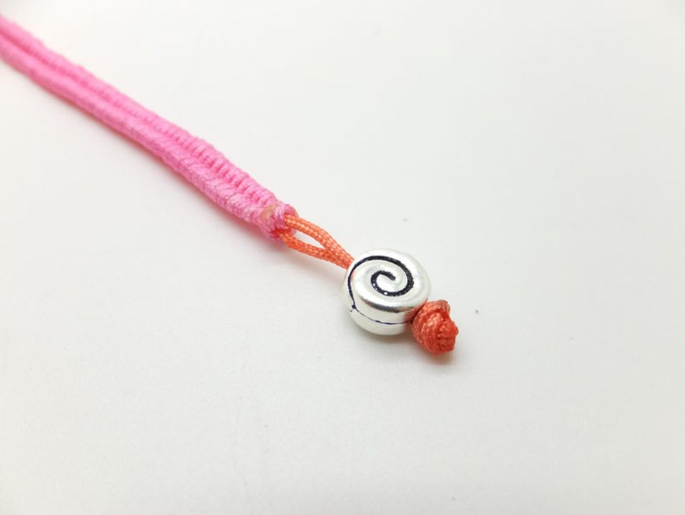 Trim the excess cords and burn the tail of cords.