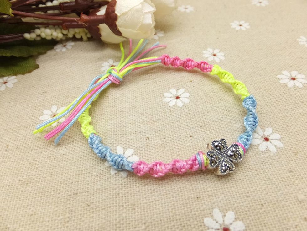 Trim the excess cords and tie a small knot to secure your bracelet.