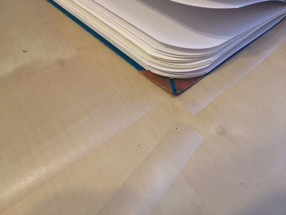 Trim the rectangular corner piece off as shown. Do the same to the other corner of the same cover.