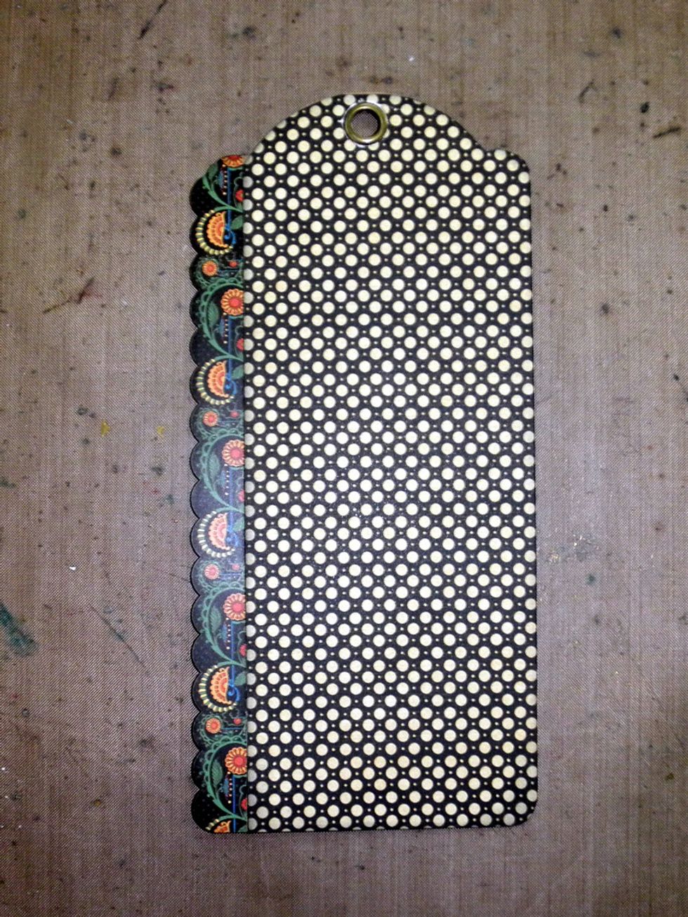 Trim the scalloped sticker border shown to 8" and attache to the left side of the tag.