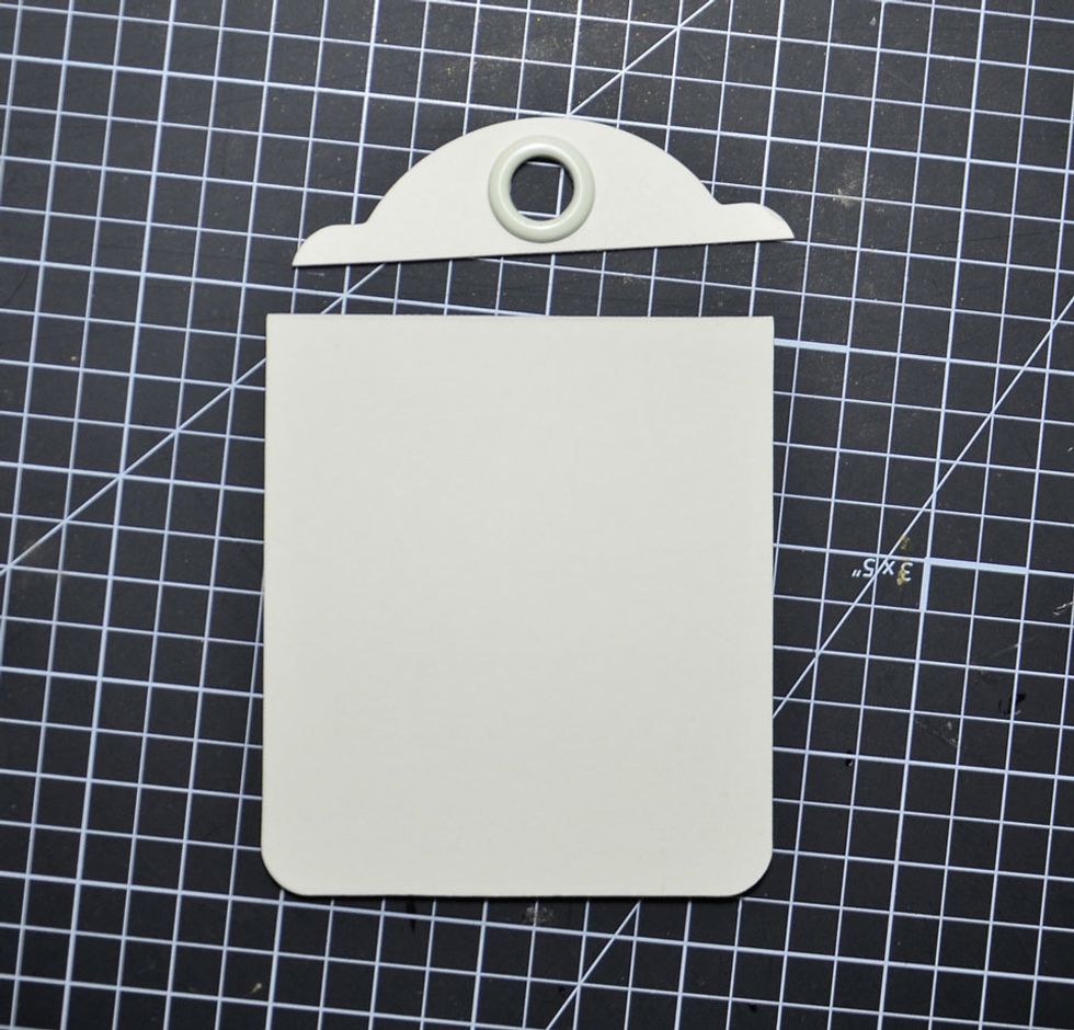 Trim the top off of the other small tag as shown.