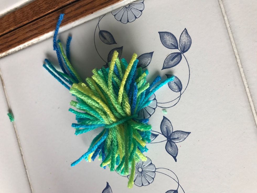 Trim the yarn at the bottom at top until you like the length