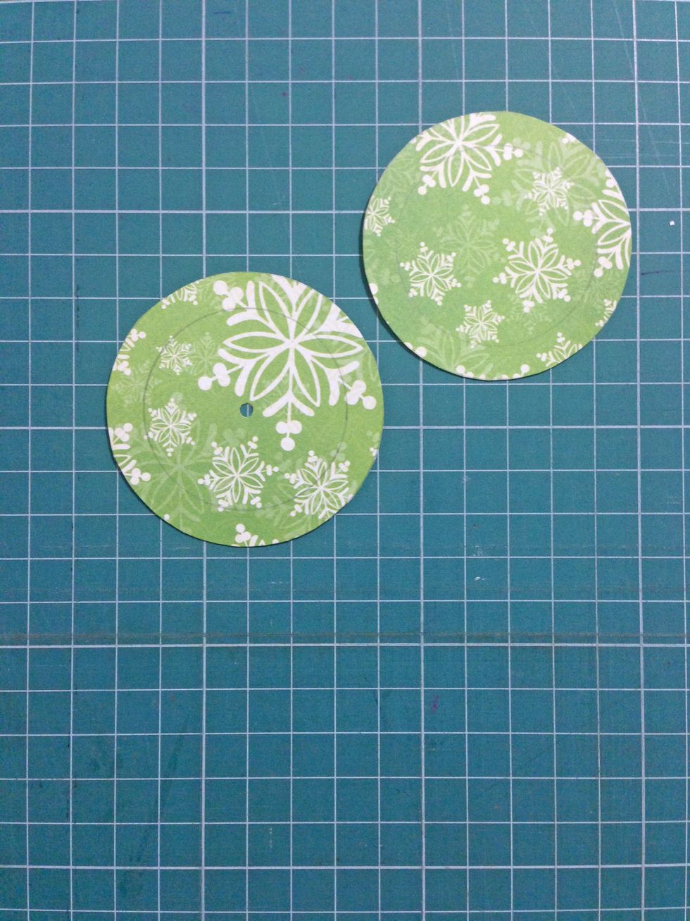 Trim them out and punch a small hole at the center on one of the circles as shown...