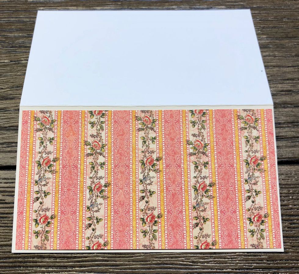Trim your design paper to measure 1/8 inch smaller than the front of your notecard. Ink the edges of your design papers with Photogenic ink to make the pattern paper stand out from the white cardstock