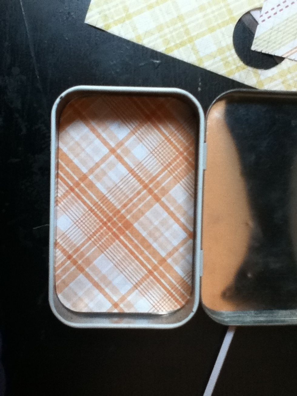 Trim your paper until it fits snugly inside the bottom of your tin.