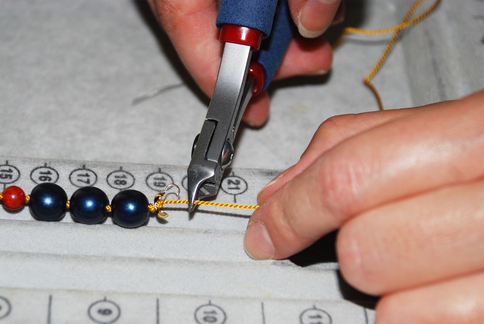 Trim your string about 1/2" past the last knot (on the other side of the clamshell end-cap).