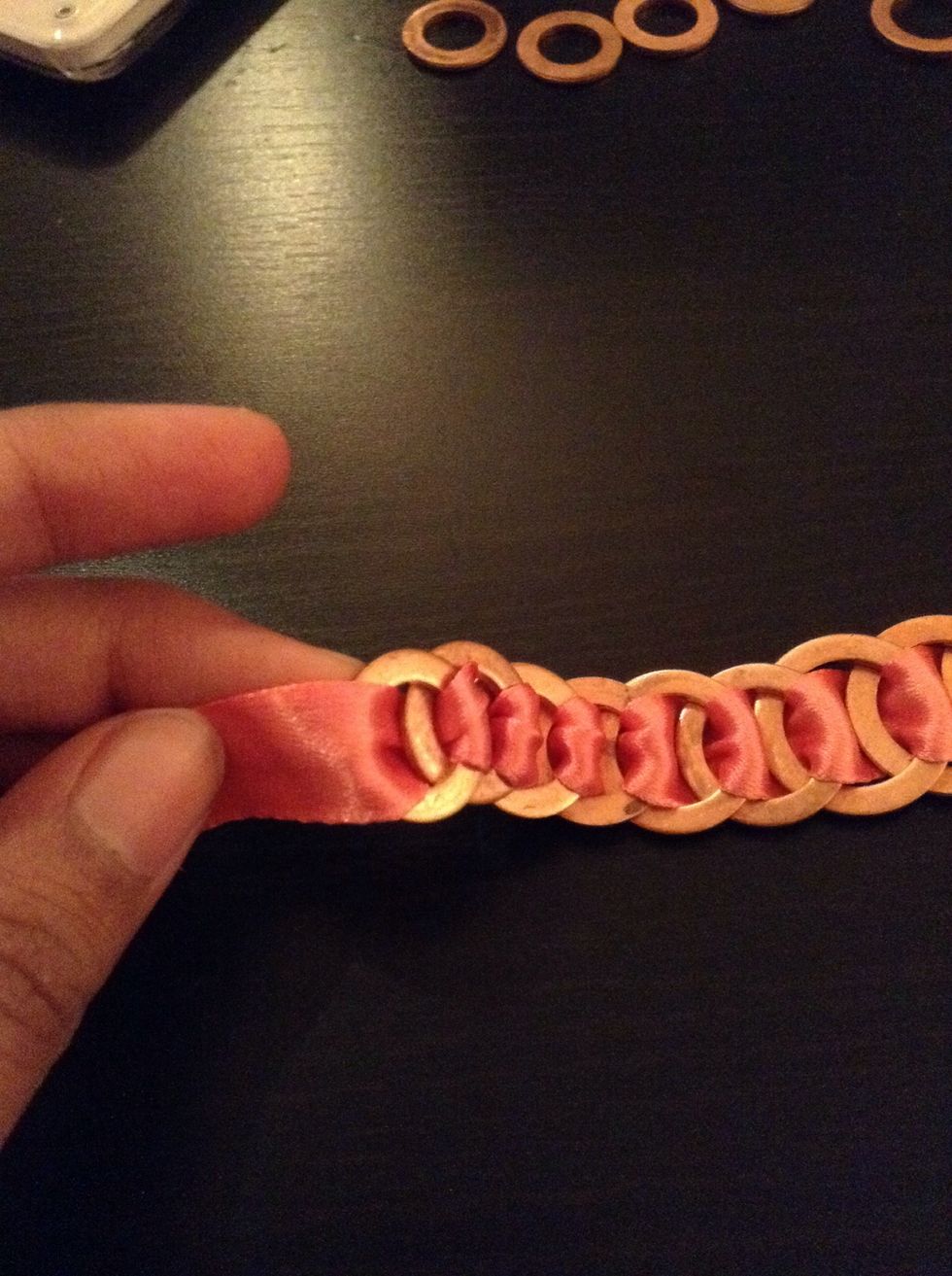 Try keeping the ribbon as neat as you can and complete the necklace.