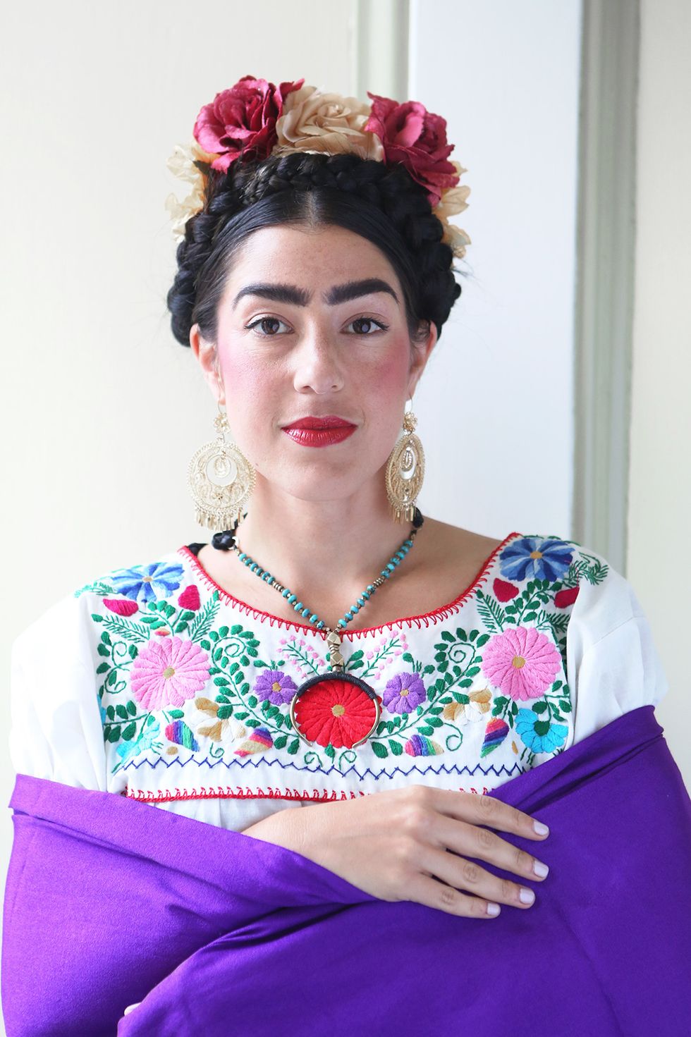 Tuck a floral crown (real or fake!) behind your braids and put on an embroidered shirt. And, ta-da, Frida in the flesh! This costume's a work of art.