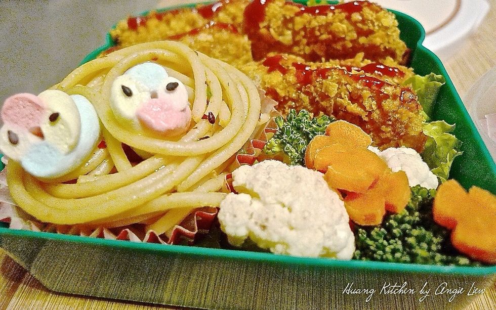 Tuck in the other corner with steamed green broccoli and cauliflower florets, cherry tomatoes and carrot flowers for extra veggie servings.