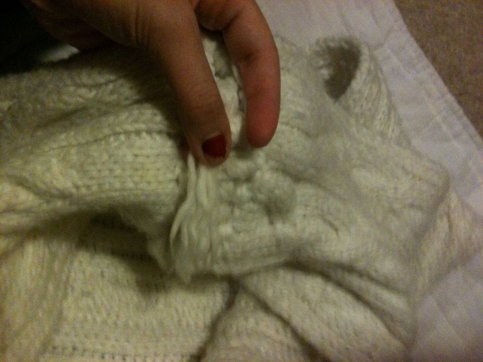 Tuck it through the loops to the other side.