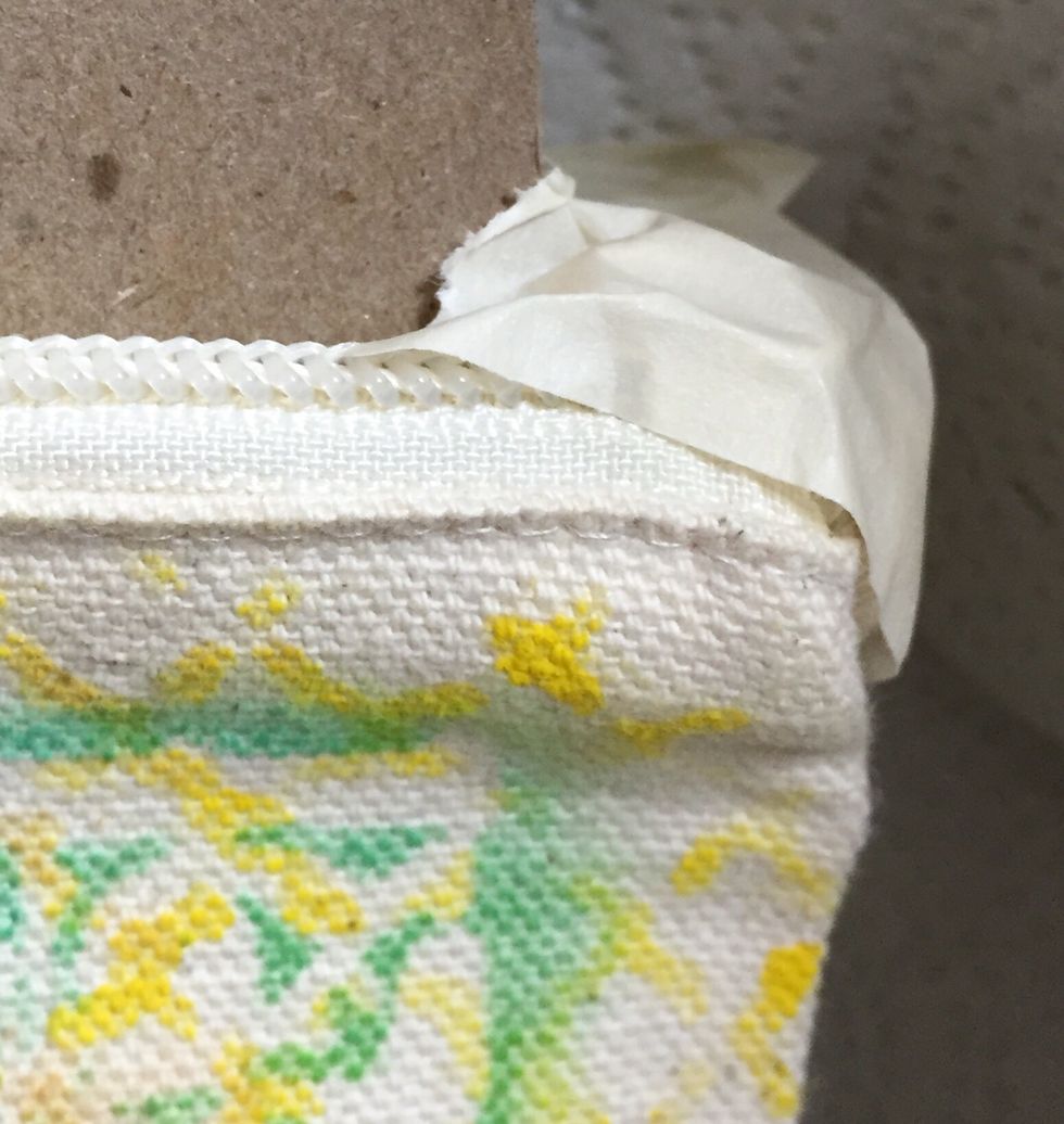 tuck strap into back of bag and tape off corners where it shows above the bag.