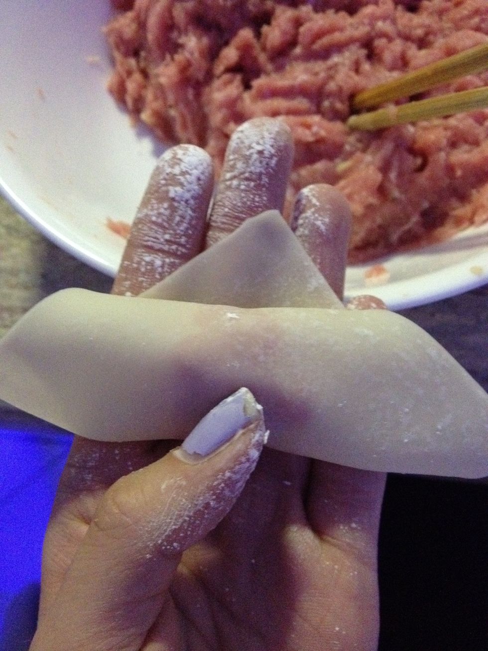 Tuck the corner into the bottom of the mince and roll up till about that much