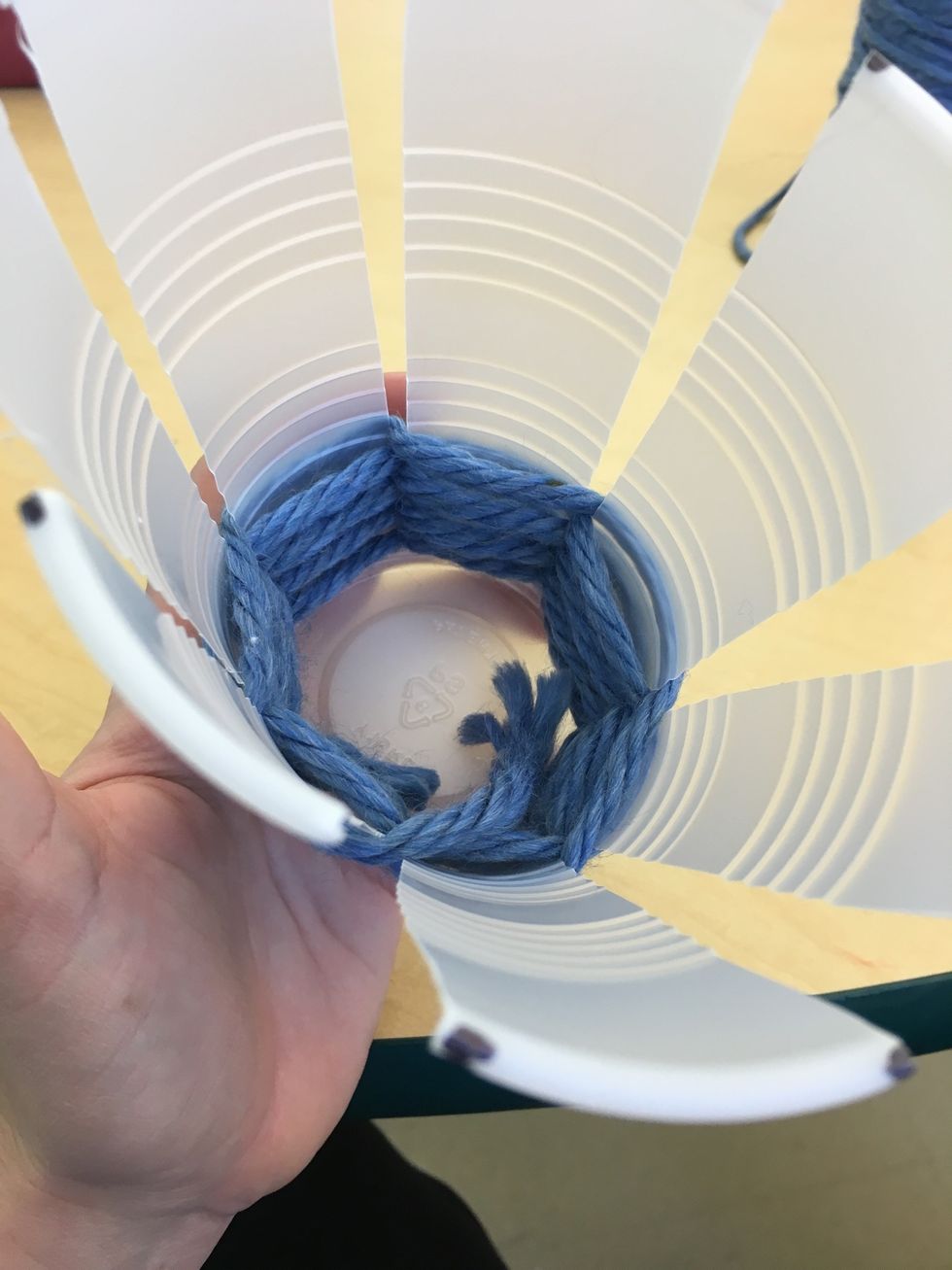 Tuck the end of the yarn inside the cup.