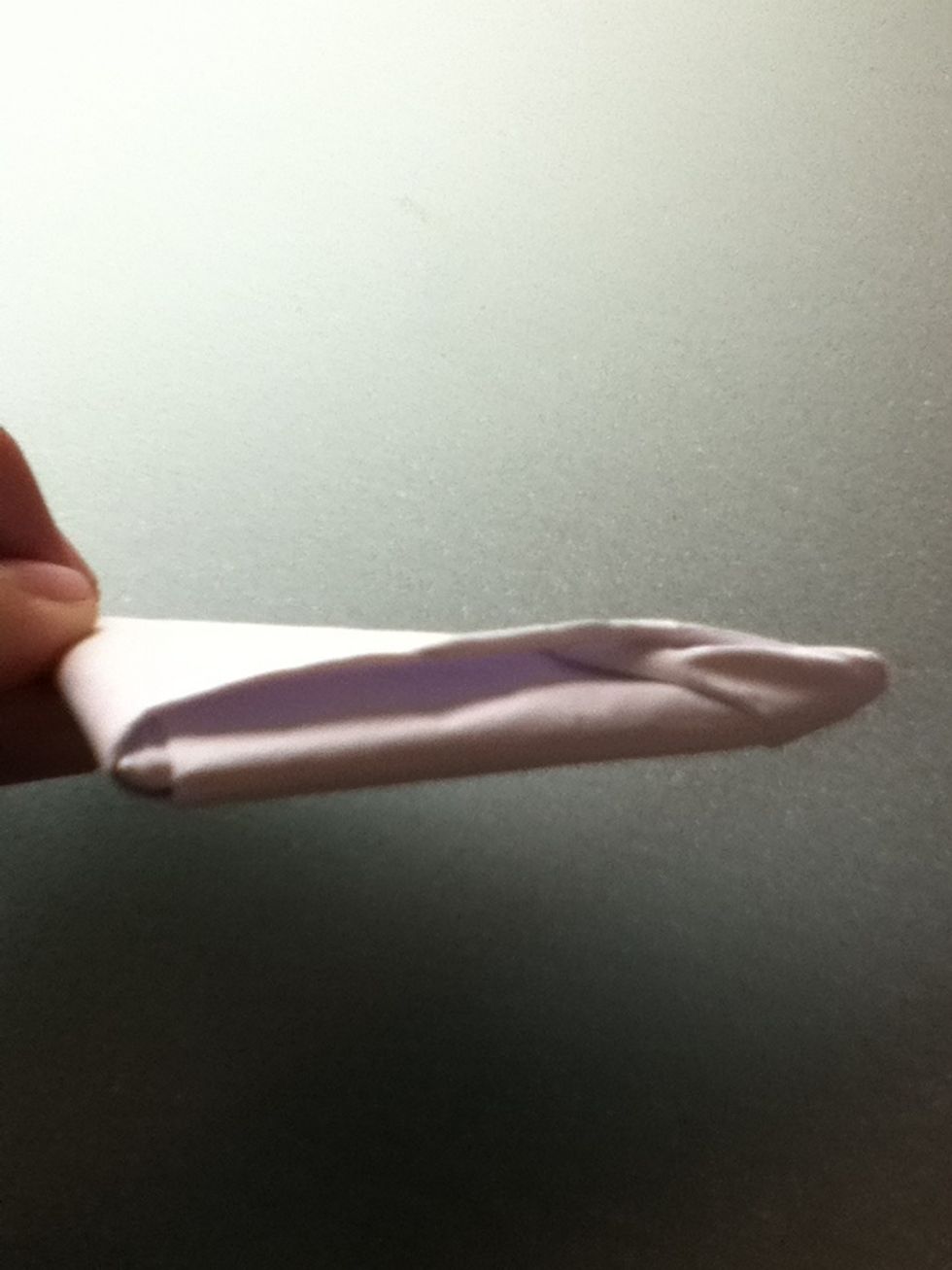 Tuck the extra paper into the flap as shown.