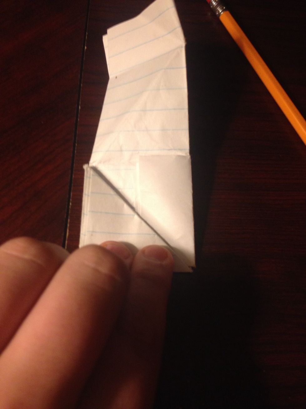 Tuck the extra portion into the triangle