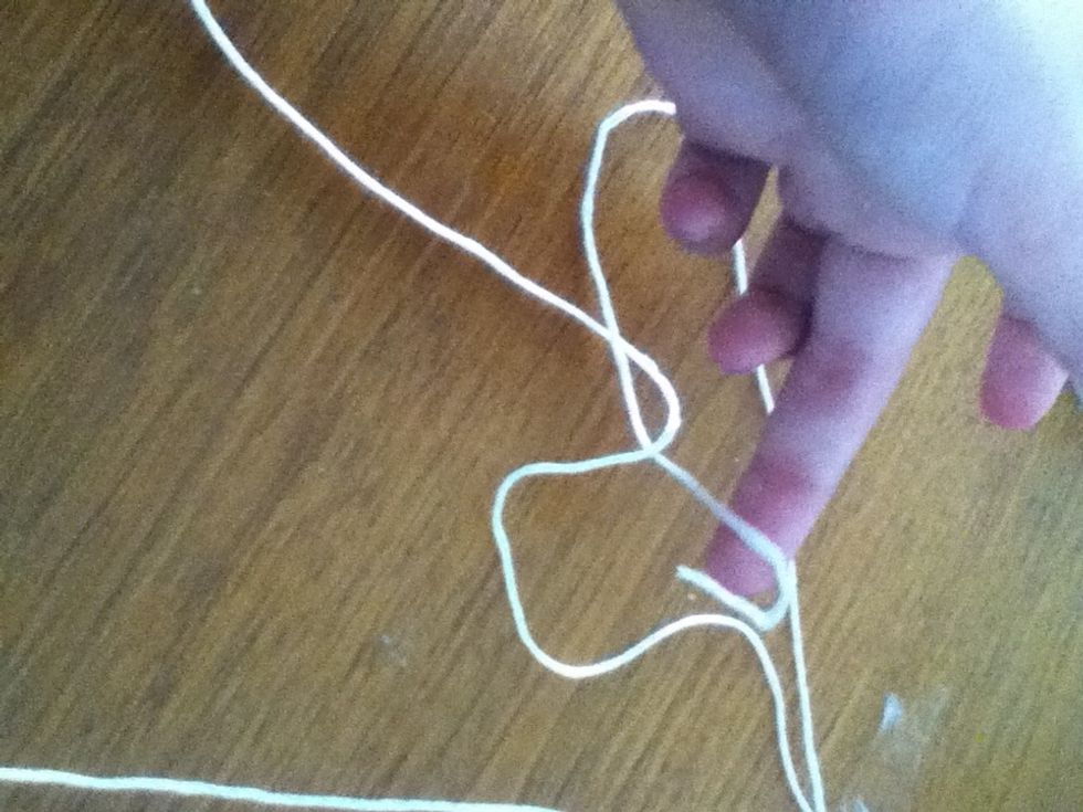 Tuck the first string under and tighten
