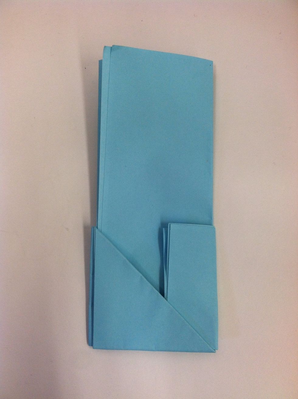 Tuck the hanging portion into the triangular pocket. Now the bottom portion makes a square.