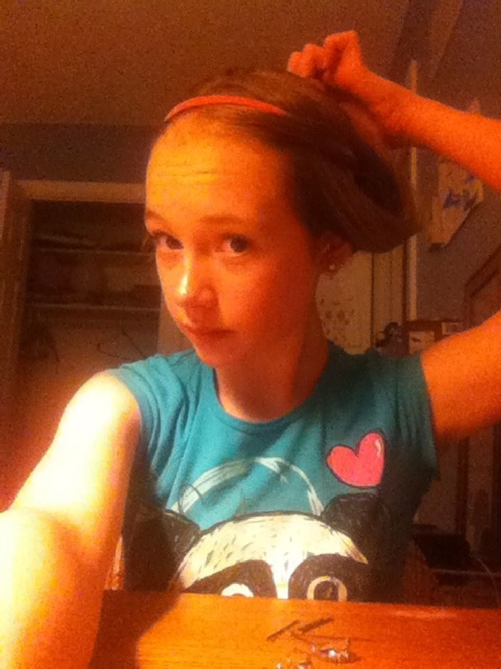 Tuck the hear into the head band in the back