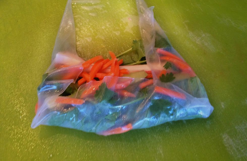 Tuck the ingredients into the paper, bottom first. Then fold each side over. Carefully roll the paper up. Place, seam side down, on waxed paper, making sure the rolls do not touch.