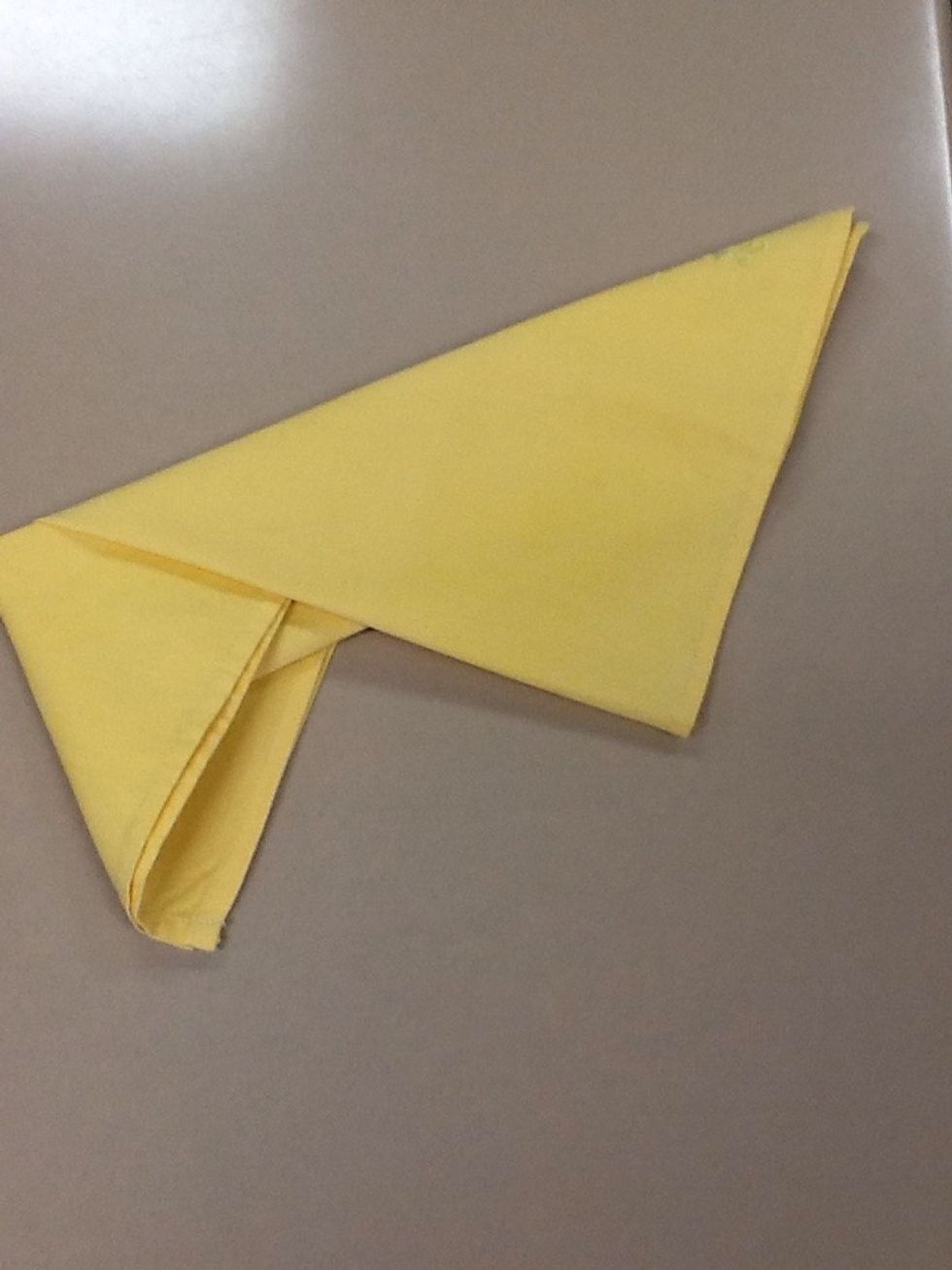 Tuck the left point into the fold.