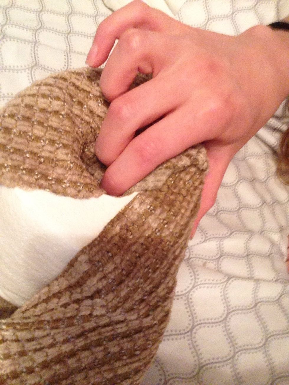 Tuck the material into the center of the roll.