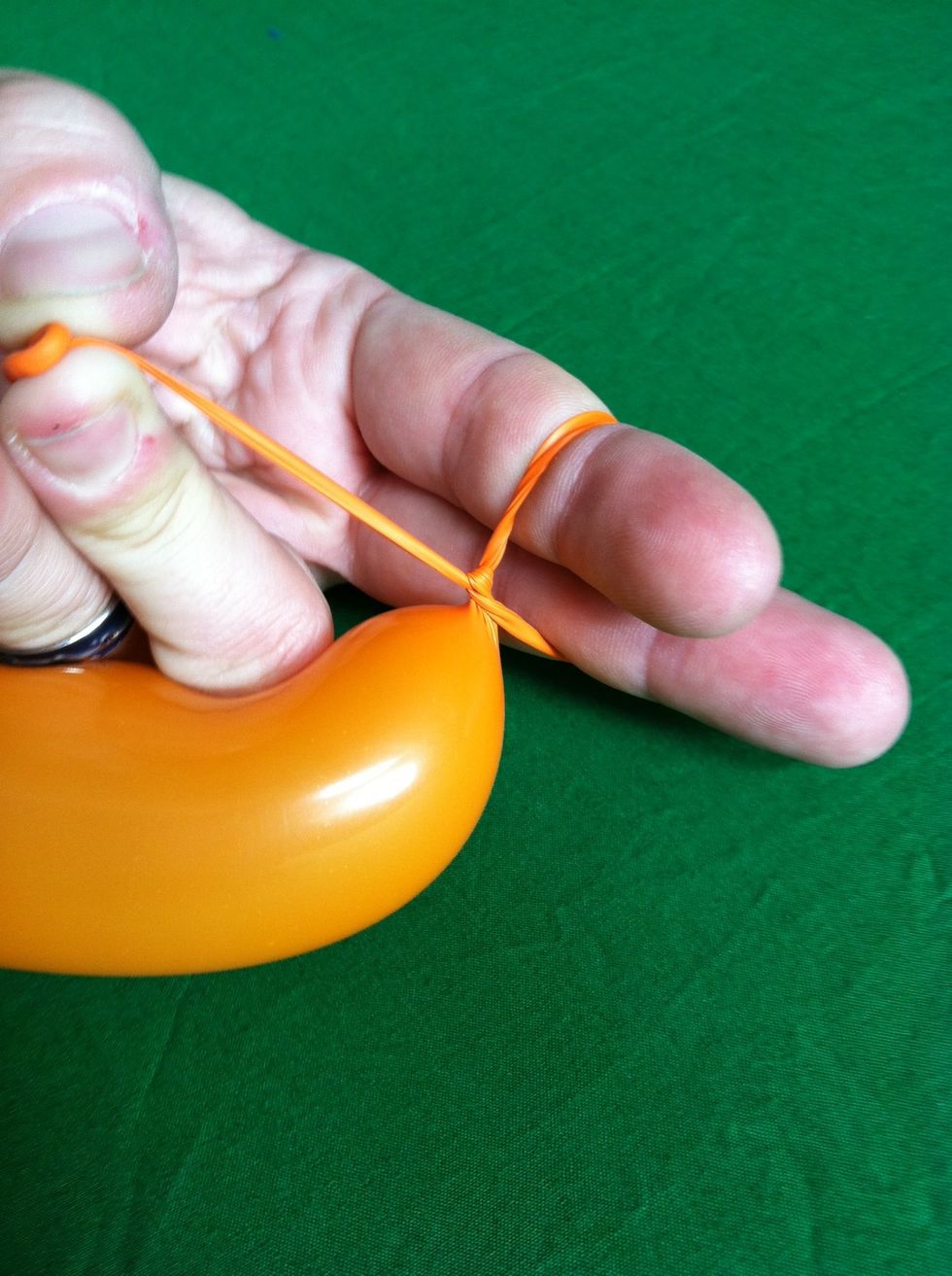 Tuck the nozzle up through the loop you've made and pull up on the nozzle while you take your fingers out.